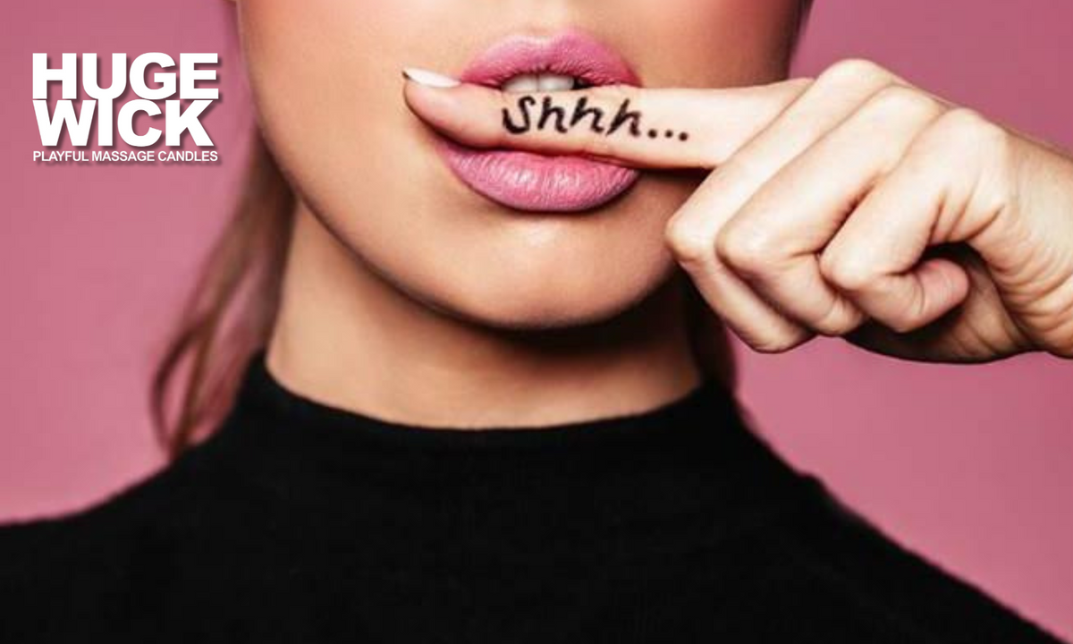 Woman holding a finger to her lips in a playful shhh gesture, Hugewick Candles