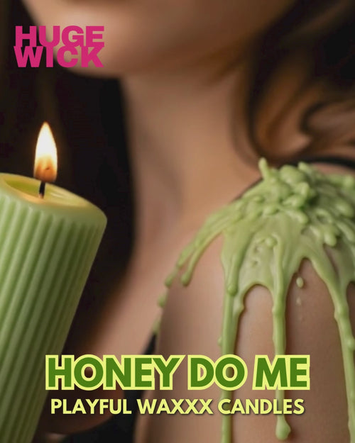 Green Honey Do Me wax play candle with wax drips on a woman's shoulder